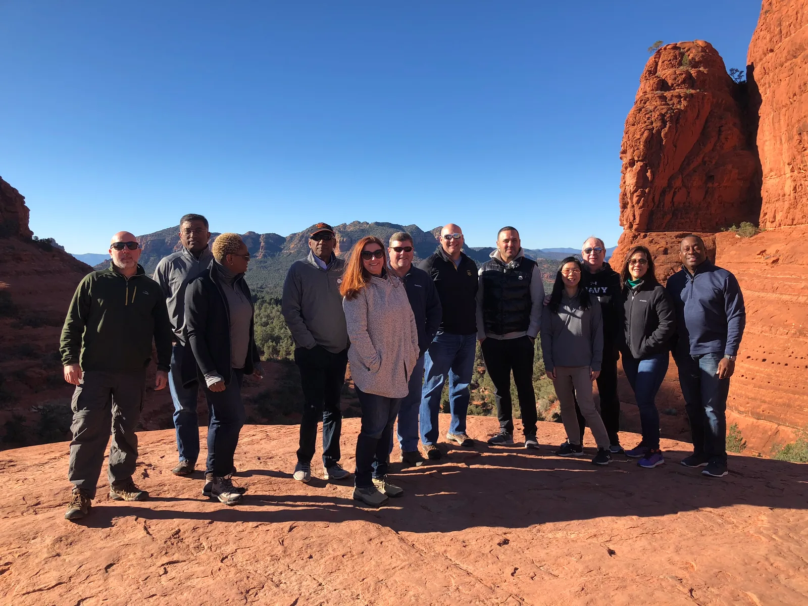 Executive leadership team on a red-rock summit during a Sedona offsite