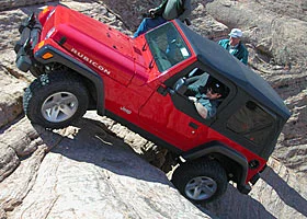 Red Jeep rock crawling on the Rubicon Trail, California