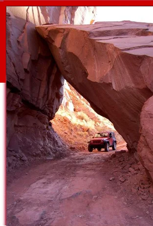 Executive off-road retreat vehicle in a red rock canyon arch near Moab, Utah