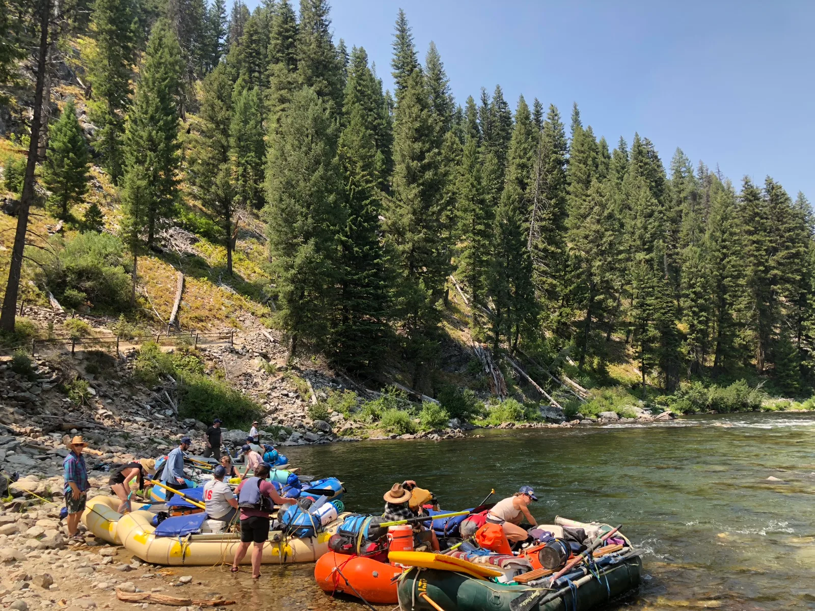 Executive team raft expedition launching on a remote wilderness river