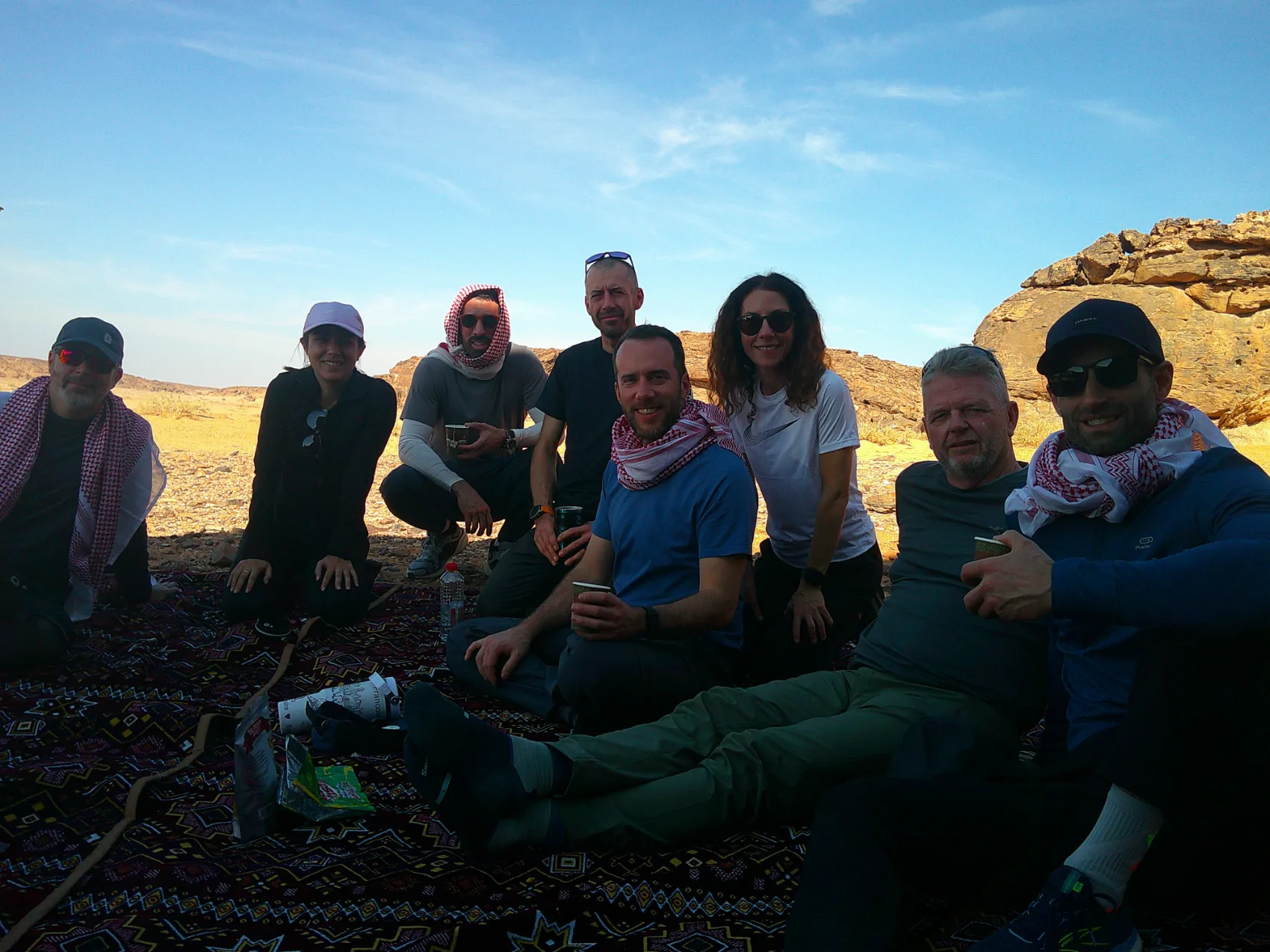 An executive leadership team sharing a quiet moment together in the desert on a Be Legendary retreat