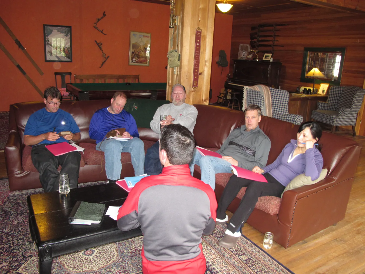 An executive leadership team in a working session at a mountain lodge